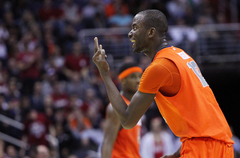 James Southerland #43 of the Syracuse Orange shoots the ball against David Kravish #45, Ricky Kreklow #24 and Allen Crabbe #23.