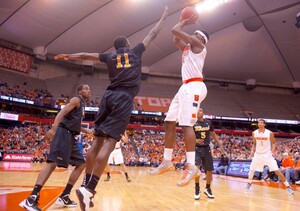 Syracuse University forward C.J. Fair shoots a jumper during the second half of the Orange's rout of Long Beach State on Thursday Night at the Carrier Dome. Fair had one of his best games of the season, registering a double-double with 16 points and 13 rebounds.
