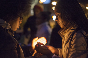 (From left) Taylor Palmer and Amber Taylor participate in a candlelight vigil for students whose families have been affected by cancer on Sunday night. Taylor was diagnosed with breast cancer in high school when she was 16 and is now a three-year cancer survivor.
