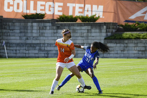 Kate Hostage, who's scored three of Syracuse's five goals this year, battles a Duke player for the ball.