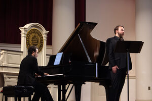 Joel David Balzun, playing the baritone, and Scott Cuellar, playing the violin, perform “Each Moment Radiant,” at Syracuse University’s Hendricks Chapel. The collection of works commemorate the 36th anniversary of the Pam Am Flight 103.
