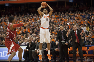 Michael Gbinije rises up for a jump shot in front of the N.C. State bench. The reserve guard played 17 minutes in Saturday's contest. 