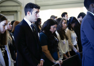 Remembrance Scholar Matthew Feibert, a biology major, listens to Dean of Hendricks Chapel Tiffany Steinwert's sermon during the convocation ceremony in Hendricks Chapel.