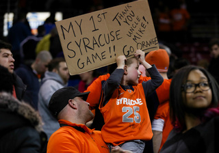 Richie Masterpol and his dad Rich, both relatives of SU assistant coach Mike Hopkins, take in the game at Conte Forum.