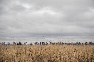 Women march from the Geo Dome in the Oceti Sakowin camp on Thanksgiving Day to show support after the initial wave of protectors gathered at the river.