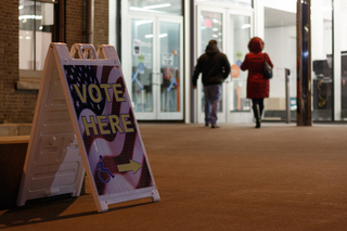 An hour before the polls close, voters still enter Huntington Hall to cast their ballots.