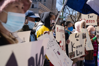 Demonstrators listen as speakers share stories of ethnic violence toward the Karen in Myanmar.