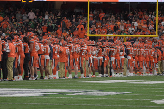 As the clock ticked closer to kickoff, the entirety of both teams moved from the sidelines arm in arm. Every member of the teams were present at center field for the coin toss instead of just the captains. 